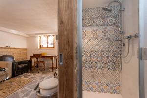a bathroom with a shower with a toilet at Baita Lodge Valfreda in Falcade +32 photos