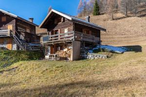 a large wooden house on a hill with at Baita Lodge Valfreda in Falcade