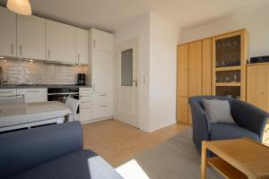 a kitchen and living room with a couch and a table at Ferienwohnung Filter in Hörnum