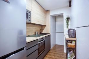 a small kitchen with a sink and a stove at The Clock Tower Apartment in Jaén