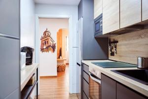 a kitchen with a sink and a counter at The Clock Tower Apartment in Jaén +12 photos