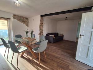 a living room with a glass table and chairs at Bella vista 2 in Castellino Tanaro +9 photos