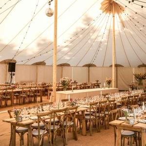 a large tent with tables and chairs in it at Lodsoldermandsgården in Rørvig