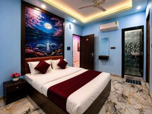 a bedroom with a large bed with a painting on the wall at Hotel 5G in Bhopal +16 photos