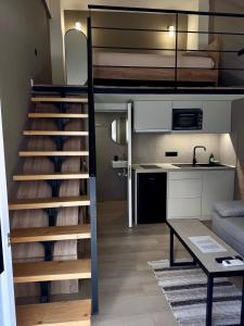 a loft bed with a staircase in a room at Loft 73 in Kalamata