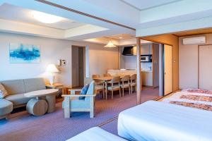 a hotel room with two beds and a dining room at Seagaia Forest Condominiums in Miyazaki