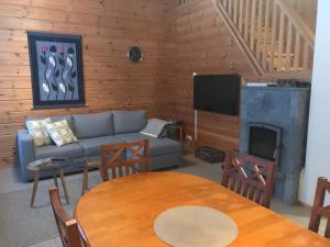a living room with a couch and a fireplace at Tenutahko in Tahkovuori