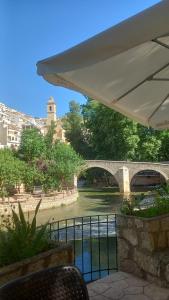 a stone bridge over a river with a bridge istg istg at Eclipse del Júcar Luna in Alcalá del Júcar