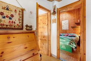 a bedroom with a bed in a wooden room at La Tana con l'Ermellino in Morgex