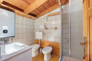 a bathroom with a toilet and a sink at La Tana con l'Ermellino in Morgex +23 photos