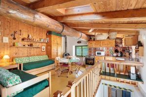 a kitchen and living room with wooden walls and wooden ceilings at La Tana con l'Ermellino in Morgex