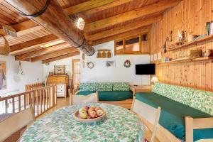 a room with a table with a bowl of fruit on it at La Tana con l'Ermellino in Morgex