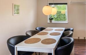 a white table with black chairs in a room at Beautiful Home In Holbæk With Wifi in Holbæk
