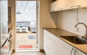 a kitchen with a view of a living room at Beautiful Home In Holbæk With Wifi in Holbæk +5 photos