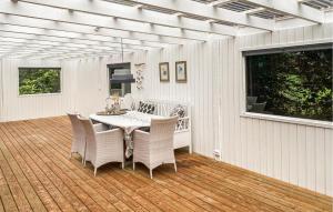 a patio with a table and chairs on a deck at Beautiful Home In Holbæk With Wifi in Holbæk