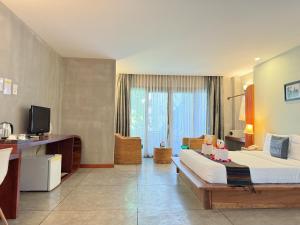 a hotel room with a bed and a television at Saravoan Royal Palace in Phnom Penh