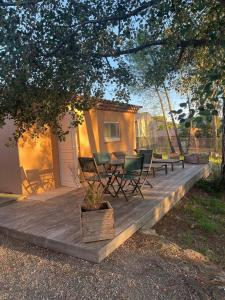 a wooden deck with a table and chairs on it at La Villa D’Aimée in Vidauban