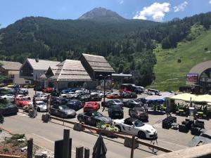 a parking lot with cars parked in front of a building at Grand Hôtel & Spa NUXE Serre Chevalier in Saint-Chaffrey
