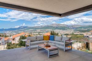 a living room with a couch and a table at Panorama Coastal Haven in Split +33 photos