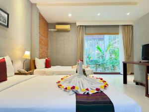 a hotel room with a wedding dress on a bed at Saravoan Royal Palace in Phnom Penh +146 photos
