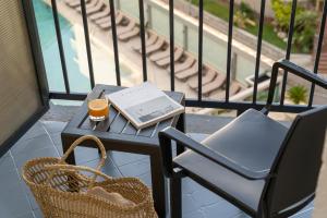 Ein Tisch mit einem Buch und einem Glas Bier auf einem Balkon in der Unterkunft Hotel Helios Lloret in Lloret de Mar