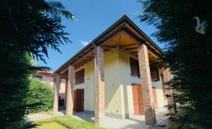 a house with brick columns and a roof at CR BnB Rozzano in Rozzano