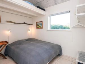 a bedroom with a bed and a window at 4 star holiday home in Børkop in Børkop