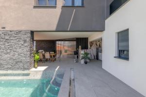 an external view of a house with a swimming pool at Panorama Coastal Haven in Split