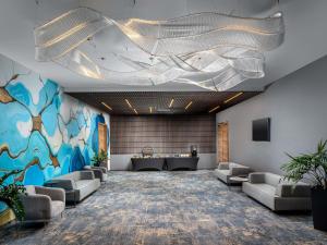 a meeting room with couches and a table in the middle at Mercure Conacul Cozieni in Bucharest
