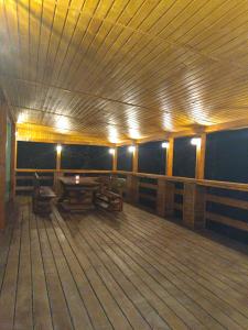 a room with a wooden deck with lights on it at Cabana 7 izvoare in Remeţi