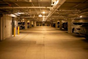 an empty parking garage with cars parked in it at Grand Hôtel & Spa NUXE Serre Chevalier in Saint-Chaffrey