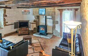 a living room with a wood burning stove in it at 2 Bedroom Gorgeous Home In Noyal-Sous-Bazouges in Noyal-sous-Bazouges