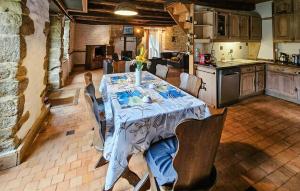 a dining room with a table and a kitchen at 2 Bedroom Gorgeous Home In Noyal-Sous-Bazouges in Noyal-sous-Bazouges