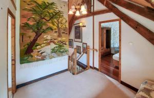 a hallway in a house with a painting on the wall at 2 Bedroom Gorgeous Home In Noyal-Sous-Bazouges in Noyal-sous-Bazouges +16 photos