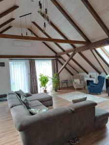 a large living room with a couch and chairs at Főnix Badacsony in Badacsonytomaj