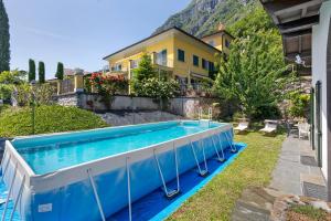 a swimming pool in the yard of a house at Villa Porlezza Lake view in Cima