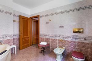 a bathroom with a toilet and a sink at Villa Porlezza Lake view in Cima +29 photos
