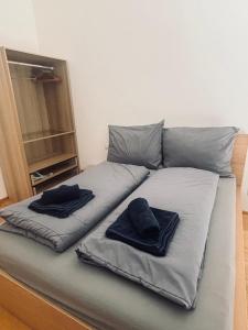 a bed with two pillows on top of it at Penthouse mit Seeblick & Terrasse Top 7 in Reifnitz