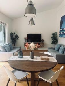 a living room with a table and chairs at Penthouse mit Seeblick & Terrasse Top 7 in Reifnitz