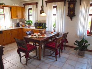 a kitchen with a wooden table and chairs in it at Ferienhaus am Badesee 4 in Aurich