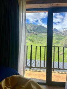 a bedroom with a window with a view of a mountain at Grand Hills Kazbegi in (( Gergeti ))