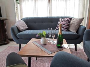 a bottle of champagne and glasses on a table in a living room at Ferienhaus am Badesee 4 in Aurich