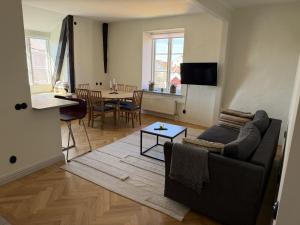 a living room with a couch and a table at Apartments Strandgatan Visby in Visby