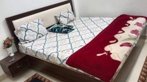 a small bed with pillows and a blanket on it at Pandeyji stay in Ayodhya
