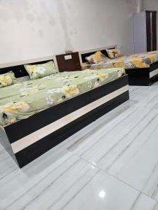 two twin beds in a room with at Pandeyji stay in Ayodhya