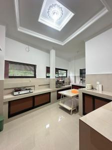 a large kitchen with a skylight in the ceiling at Hideaway in Amed