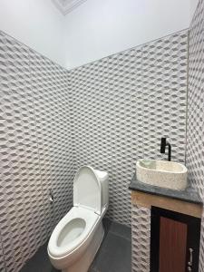 a bathroom with a toilet and a sink at Hideaway in Amed +12 photos