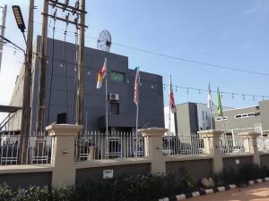 a building with flags in front of it at Wesley Hotels in Benin City