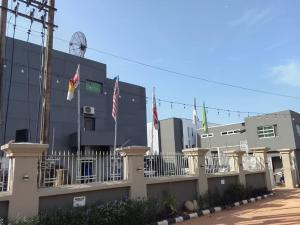 a building with flags in front of it at Wesley Hotels in Benin City