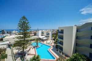 an aerial view of a building and a swimming pool at Ibiscos Garden Hotel in Rethymno